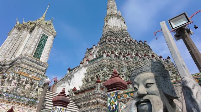 BANGKOK, THAILAND - 6th OCTOBER 2024: Camera tilts to Buddha statue from Thonburi Pagoda of Wat Arun in Bangkok Thailand on a sunny morning