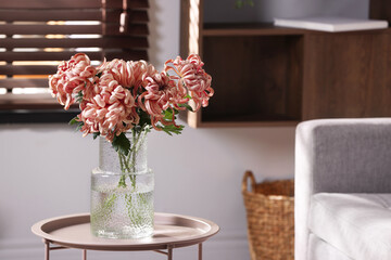 Beautiful pink chrysanthemum flowers in vase on coffee table indoors, space for text