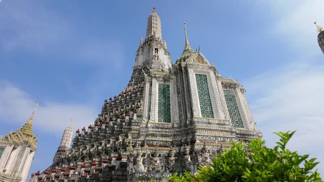 BANGKOK, THAILAND - 6th OCTOBER 2024: Camera tracks around the Thonburi Pagoda of Wat Arun in Bangkok Thailand on a sunny morning