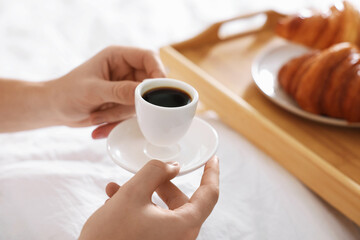 Man having coffee in bed, closeup. Hotel room service