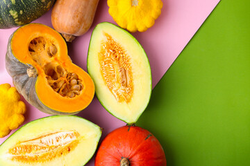 Many fresh pumpkins and other gourds on color background, flat lay. Space for text