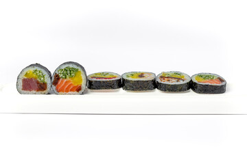 Sushi roll mix on a white dish on a white background isolated
