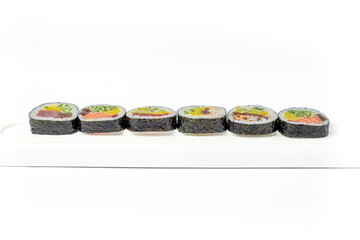 Sushi roll mix on a white dish on a white background isolated