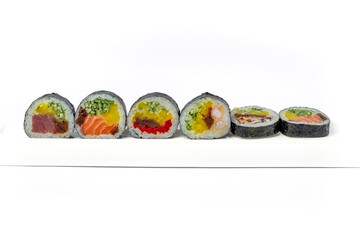Sushi roll mix on a white dish on a white background isolated