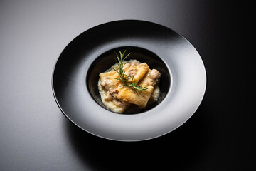 black plate of Italian pasta macaroni on black background