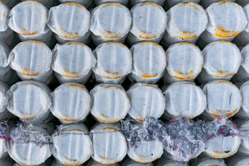 Fototapeta premium Close-up of pocket mattress springs wrapped in white fabric, forming a regular pattern with visible fibers and discolorations on the surface