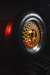 old retro stylish wheels collapsible two-component with a gold center and shiny rims for car tuning long exposure photo to simulate movement