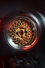 old retro stylish wheels collapsible two-component with a gold center and shiny rims for car tuning long exposure photo to simulate movement