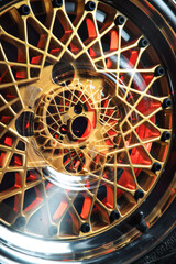 old retro stylish wheels collapsible two-component with a gold center and shiny rims for car tuning long exposure photo to simulate movement