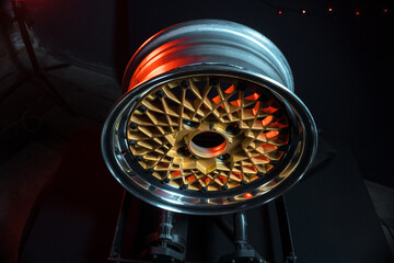 old retro stylish wheels collapsible two-component with a gold center and shiny rims for car tuning long exposure photo to simulate movement