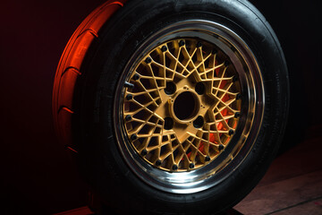 old retro stylish wheels collapsible two-component with a gold center and shiny rims for car tuning long exposure photo to simulate movement