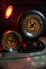old retro stylish wheels collapsible two-component with a gold center and shiny rims for car tuning long exposure photo to simulate movement