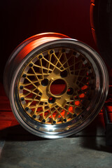 old retro stylish wheels collapsible two-component with a gold center and shiny rims for car tuning long exposure photo to simulate movement
