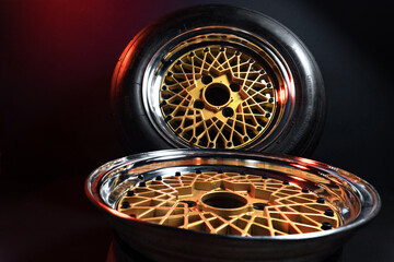 old retro stylish wheels collapsible two-component with a gold center and shiny rims for car tuning long exposure photo to simulate movement