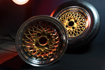 old retro stylish wheels collapsible two-component with a gold center and shiny rims for car tuning long exposure photo to simulate movement