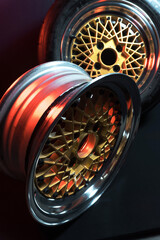 old retro stylish wheels collapsible two-component with a gold center and shiny rims for car tuning long exposure photo to simulate movement