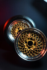 old retro stylish wheels collapsible two-component with a gold center and shiny rims for car tuning long exposure photo to simulate movement