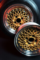 old retro stylish wheels collapsible two-component with a gold center and shiny rims for car tuning long exposure photo to simulate movement