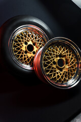 old retro stylish wheels collapsible two-component with a gold center and shiny rims for car tuning long exposure photo to simulate movement