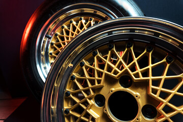 old retro stylish wheels collapsible two-component with a gold center and shiny rims for car tuning long exposure photo to simulate movement