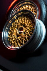 old retro stylish wheels collapsible two-component with a gold center and shiny rims for car tuning long exposure photo to simulate movement