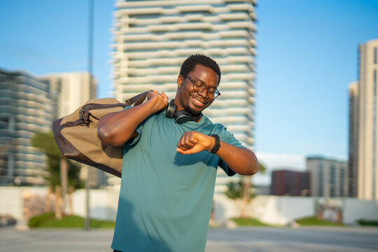 African american man checking smartwatch before workout