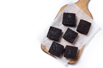 Homemade chocolate brownies on cutting board isolated on white background. Top view. Copy space