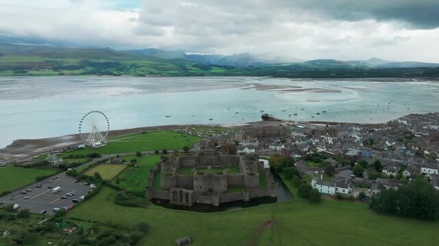Beaumaris⁩, Wales, Castle Static with town, Manai Strait and mountains in the background