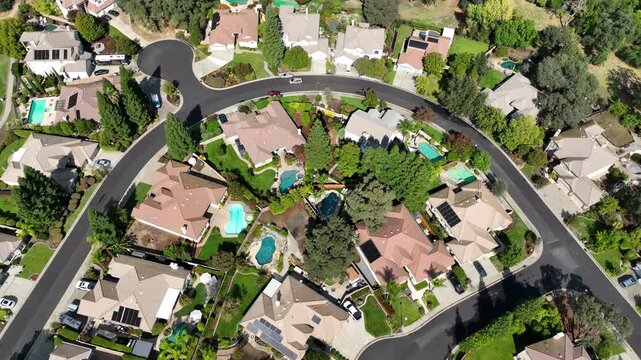 High angle drone shot circling above wealthy homes in Roseville,California