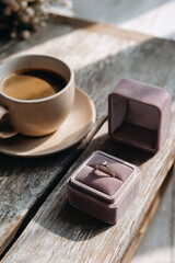 Valentine&rsquo;s Day minimalist editorial &mdash; coffee and ring box in sunlight, vertical 4:5