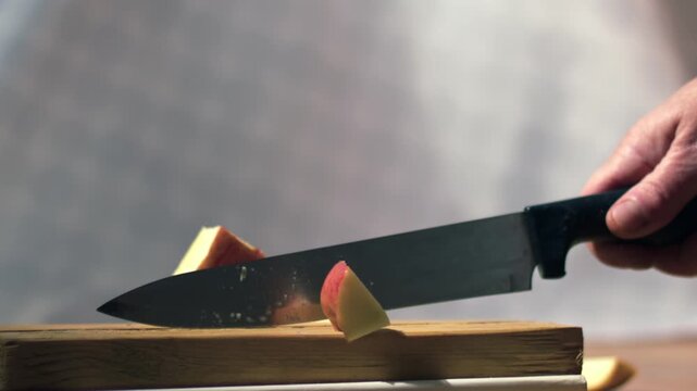Chopping apple into pieces with sharp knife
