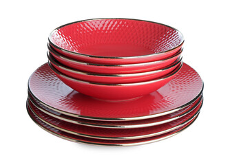 Stack of red ceramic dishware isolated on white