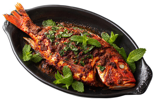  a black serving dish with a whole fried or charred red snapper on it, seasoned with indian-style spices and herbs, against a Transparent Background PNG