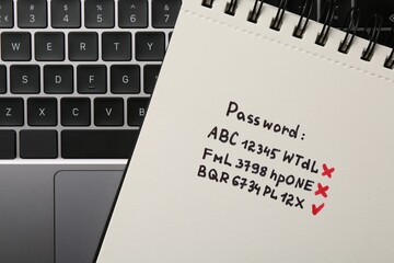 Changing password. Notebook with correct and incorrect passwords and laptop, top view
