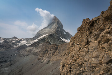 Mt. Matterhorn with clouds in the Swiss Alps during a base camp hike in Zermatt.