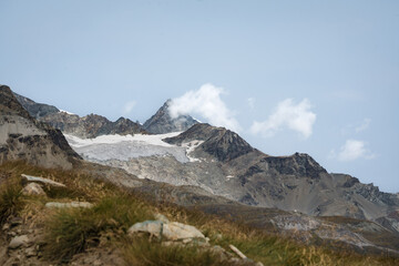 Fototapeta premium Hiking in the Swiss Alps with beautiful mountains in the background.