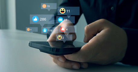 Social media,marketing, like,social network,blog,live,chat reaction and livestream.Person using smart phone with emoticon icons of Social Media.Interactive with friends on chat with emoticon feedback.