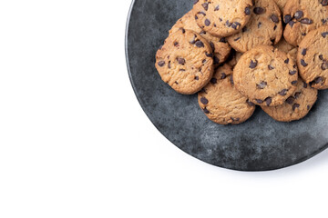 Baked chocolate chip cookies on black plate isolated on white background. Top view. Copy space