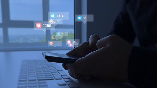 Social media,marketing, like,media, social network,blog,live,chat reaction concept.Interactive with friends on chat with emoticon feedback.Person using smart phone with emoticon icons of Social Media.