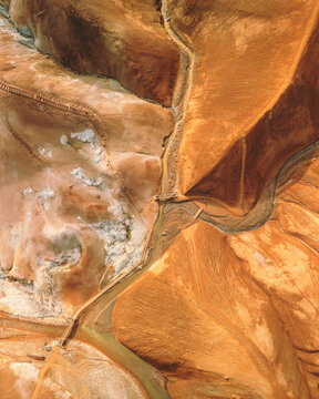 Aerial view of a stark, alien landscape where winding streams carve through ochre and cream-colored earth, Kerlingarfj&Atilde;&para;ll, Hrunamannahreppur, Iceland.