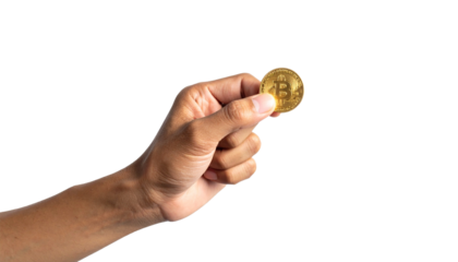 A hand holding a golden bitcoin