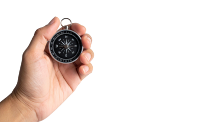A hand holding a compass, representing direction, guidance, and navigation