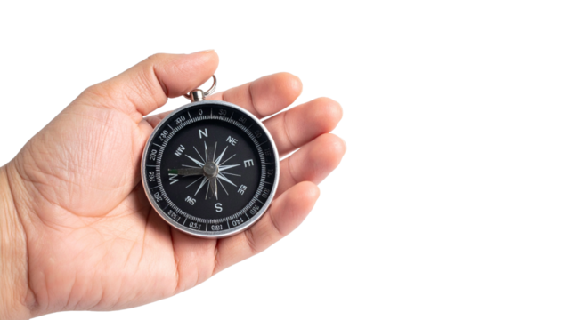 A hand holding a compass, symbolizing direction and guidance. The compass is round with a sleek design, being held by a hand. This image evokes a sense of exploration