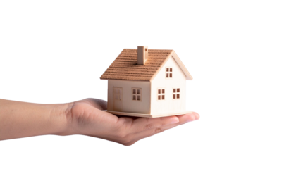 A hand offering a miniature house, representing property ownership and real estate concept. This image symbolizes home, security, and investment