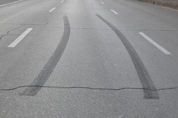 Black marks of burnt tires on asphalt after acceleration © Belogorodov