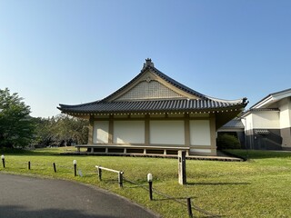 Traditional Japanese temple building with white walls and grey tiled roof in Japan