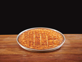 Delicious homemade savory pie with golden crispy layers, baked to perfection in a round tray. Perfect for family gatherings, traditional meals, or food photography showcasing authentic baked pastry.