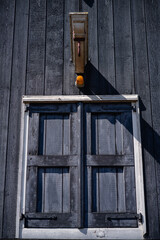 Wooden Shutters and Lantern on Dark Timber Facade - Diagonal Shadow, Vertical