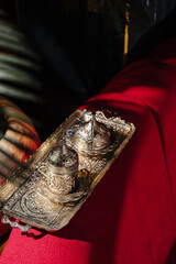 Traditional oriental metal coffee set on a red fabric background. Antique engraved coffee cups and...