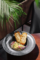 Delicious plate of local dish served with bread in a stylish setting